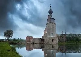 Vue d'une rue animée de Colfontaine illustrant le service de débouchage local avec ses bâtiments typiques et boutiques.